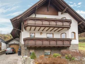 a house with a large balcony on top of it at Spacious flat in Adenau near the N rburgring in Adenau