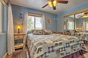 a bedroom with two beds and a mirror at Serene Pet-Friendly Cabin with Fire Pit and Loft! in Duck Creek Village