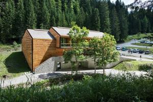 a house in the middle of a forest at Vallesinella Hotel Restaurant Bar in Madonna di Campiglio