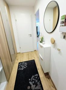 a bathroom with a black rug and a mirror at Baumkrone in Altenau
