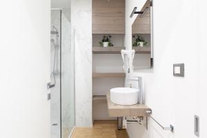 a bathroom with a sink and a shower at AC Home in Novoli +48 photos