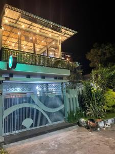 a blue gate in front of a house at night at The Safa Baiti Guest House Syariah in Rampal