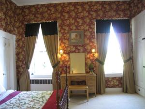 a bedroom with a bed and a mirror at Allegheny Street Bed & Breakfast in Hollidaysburg +11 photos