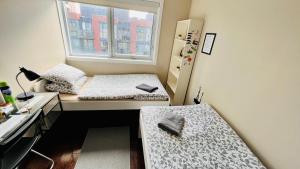 a bedroom with a bed, desk and a window at Home in Downtown in Toronto
