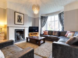 a living room with a couch and a fireplace at Royal Victoria House in Scarborough