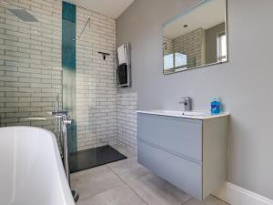 a white bathroom with a sink and a mirror at Royal Victoria House in Scarborough +58 photos