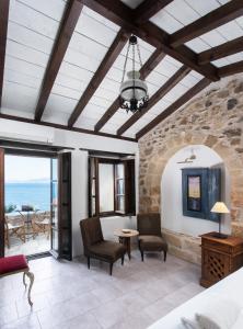 a bedroom with a room with a view of the ocean at Pablito House in Monemvasia