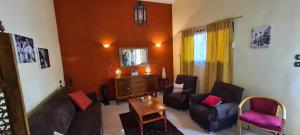 a living room with a couch and chairs and a mirror at Senmut Luxory Rooms in Luxor