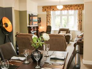 a dining room with a table and chairs and a living room at Sunningdale in Ludlow
