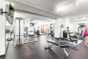 a gym with cardio equipment and a woman in a room at Sea Colony Brandywine Garden in Bethany Beach