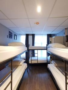 a dorm room with three bunk beds in it at Hotel Jesse in Amsterdam