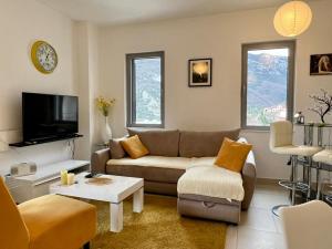 a living room with a couch and a tv at Lavender Bay Apartment C23 in Kotor