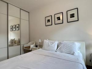 a bedroom with a white bed and a mirror at Lavender Bay Apartment C23 in Kotor