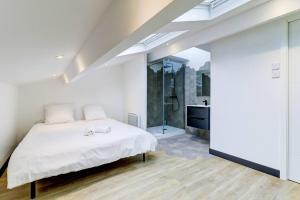 1 dormitorio con cama blanca y baño en LA CAMBUSE TOPDESTINATION-BOURG - Centre ville - Classé 3 étoiles, en Bourg-en-Bresse