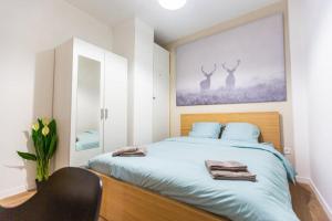 a bedroom with a bed with a picture of deer on the wall at Bel appartement Type T3 climatisé in Marseille