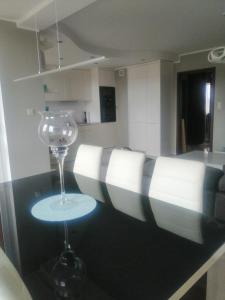 a wine glass sitting on a table in a kitchen at Apartament 35 in Olsztynek