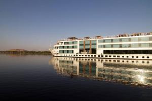 a cruise ship is docked in the water at Le Fayan Nile Cruise - Every Monday from Luxor for 4 & 7 Nights, and every Friday from Aswan for 3 & 7 Nights in Luxor