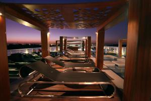a row of lounge chairs on a balcony at night at Le Fayan Nile Cruise - Till 17-9 Sat From Luxor for 4&7 Nights Wed From Aswan for 3&7 Nights - 18-9 to 20-11 Thu from Luxor for 4&7 Nights Mon From Aswan for 3&7 Nights - 22-12 Mon from Luxor for 4&7 Nights Fri From Aswan in Luxor