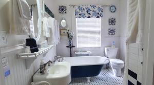 a bathroom with a tub and a sink and a toilet at Pettigru Place Bed & Breakfast in Greenville +118 photos
