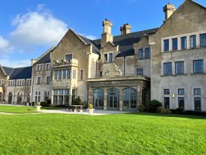 a large building with a large lawn in front of it at The Lough Erne House at Golf Village Lough Erne Resort in Enniskillen