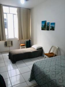Habitación de hotel con 2 camas y ventana en Studio Copacabana, en Río de Janeiro