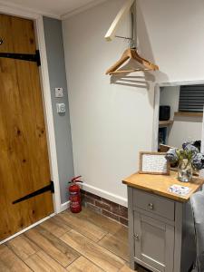 a kitchen with a counter and a wooden door at The Lodge in Little Clacton +6 photos