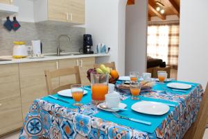 a table with a blue and white table cloth at La terra del sole in Cinisi