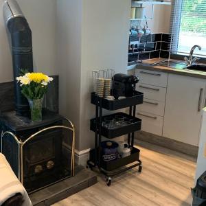 a kitchen with a fireplace and a kitchen with a sink at Bedrock Lodge in Bristol