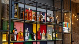 a shelf filled with lots of bottles of alcohol at Selina Salta in Salta