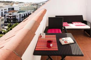 a balcony with two chairs and a table with a coffee cup at Apartment, Los Llanos de Aridane in Los Llanos de Aridane