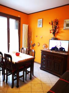 a living room with a dining room table and a television at Residence SANTA CROCE Delebio Provincia di Sondrio in Sondrio