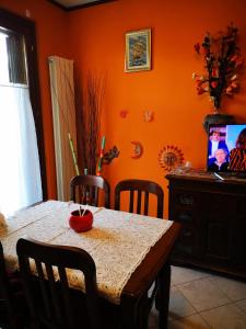 a dining room with a table with chairs and a television at Residence SANTA CROCE Delebio Provincia di Sondrio in Sondrio