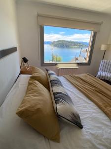 a bedroom with a large bed with a large window at Quinta Luna in San Carlos de Bariloche +68 photos