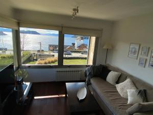 a living room with a couch and a large window at Quinta Luna in San Carlos de Bariloche