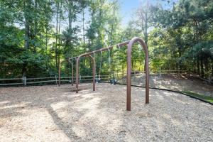 a monkey bars in a park with trees at Sea Colony - 706 Chesapeake House in Bethany Beach