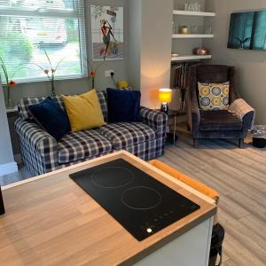 a living room with a couch and a table at Bedrock Lodge in Bristol
