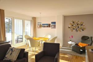a living room with a table and a dining room at Villa Stoertebeker Apartment 19 in Baabe