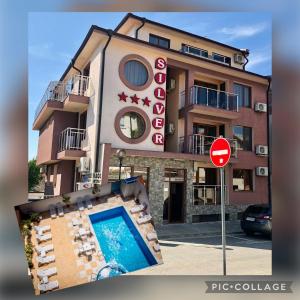 a building with a swimming pool next to a stop sign at Hotel Silver in Sozopol