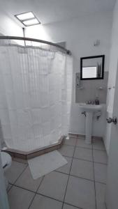 a bathroom with a shower and a toilet and a sink at Hogar tranquilo, cerca de marina y plaza comercial in Mazatlán