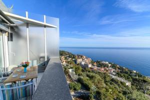 a balcony with a view of the ocean at Air-Conditioned Apartment With Sea View Furnished Terrace & Parking in Cap d'Ail