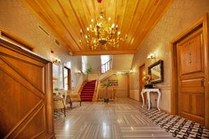 a hallway with a staircase and a chandelier at Ada Palas Buyukada in Buyukada