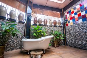 a bath room with a tub and a toilet at Lost Paradise Resort in Batu Ferringhi