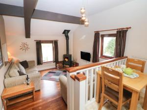 a living room with a couch and a table at Horse Mill Lodge in Taddington