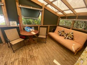 a room with a couch and a table and windows at Virgin Islands Campground in Water Island