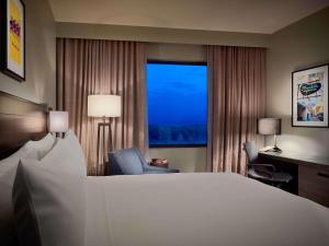 a hotel room with a large bed and a window at Sonesta Bee Cave Austin Hill Country in Bee Cave