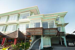 a building with a balcony on the side of it at The Studio Inn Nusa Dua in Nusa Dua