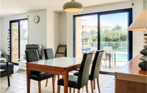a dining room with a table and chairs at Gorgeous Home In Saint-Germain-Sur-Ay in Saint-Germain-sur-Ay