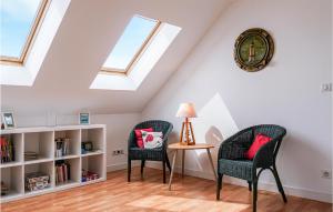 two chairs and a table in a room with skylights at Gorgeous Home In Saint-Germain-Sur-Ay in Saint-Germain-sur-Ay