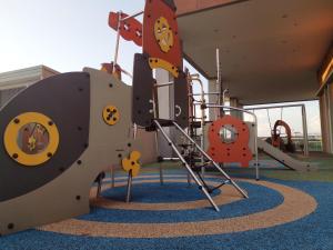 a play room with a playground with a slide at Bell Family Suite @Sepang Kota Warisan KLIA in Sepang