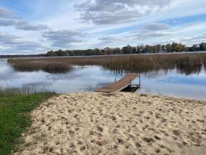 a dock in the middle of a body of water at Amazing Lakefront Retreat On Long Lake! home in Portage